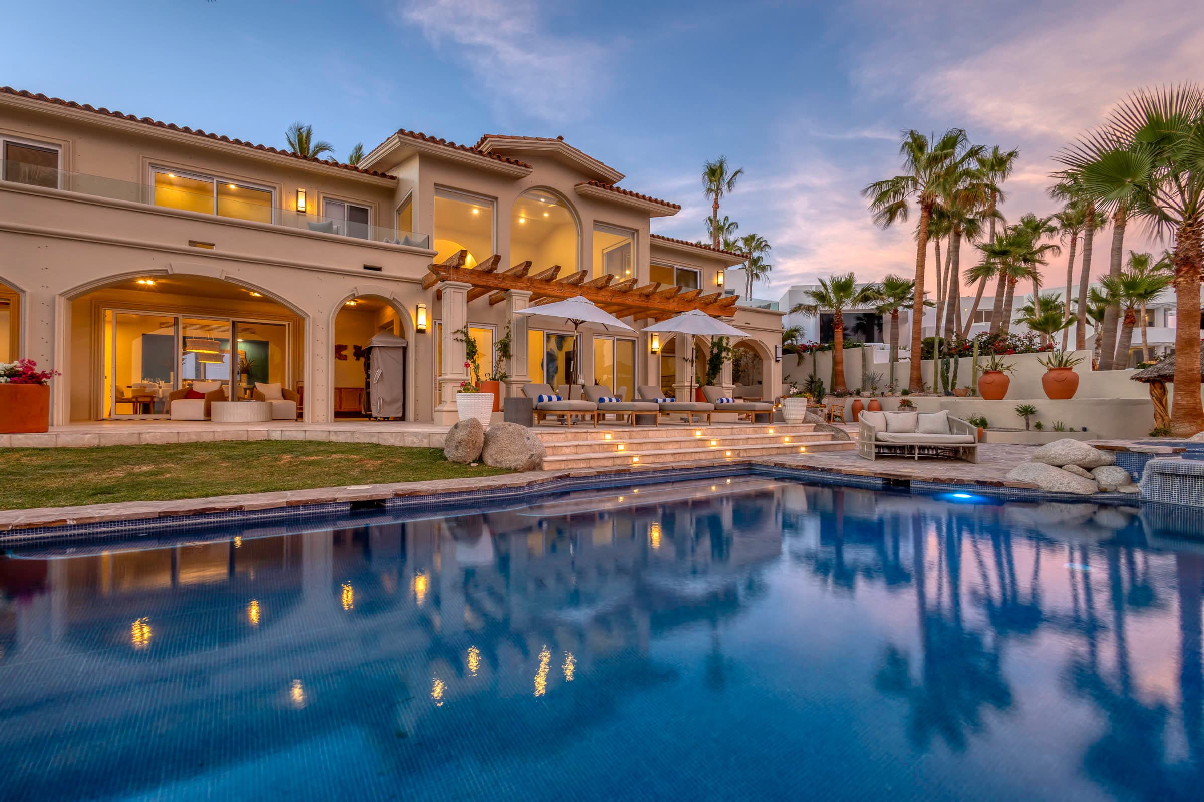 A villa and its pool at dusk